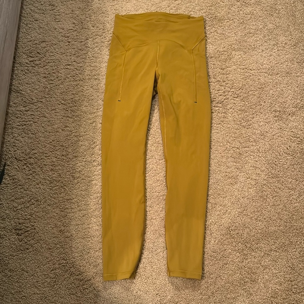 Lululemon leggings with pockets.  New without tags.  Size 6.  Golden yellow.